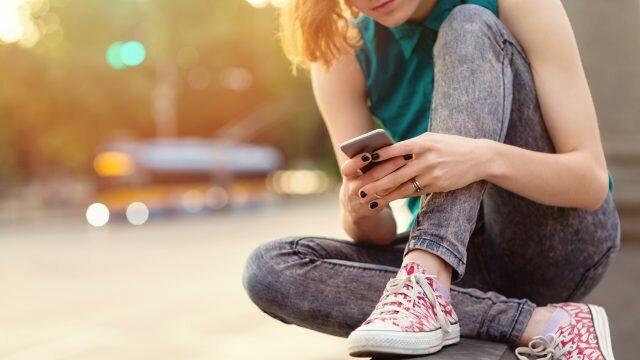 Woman using social media on her phone